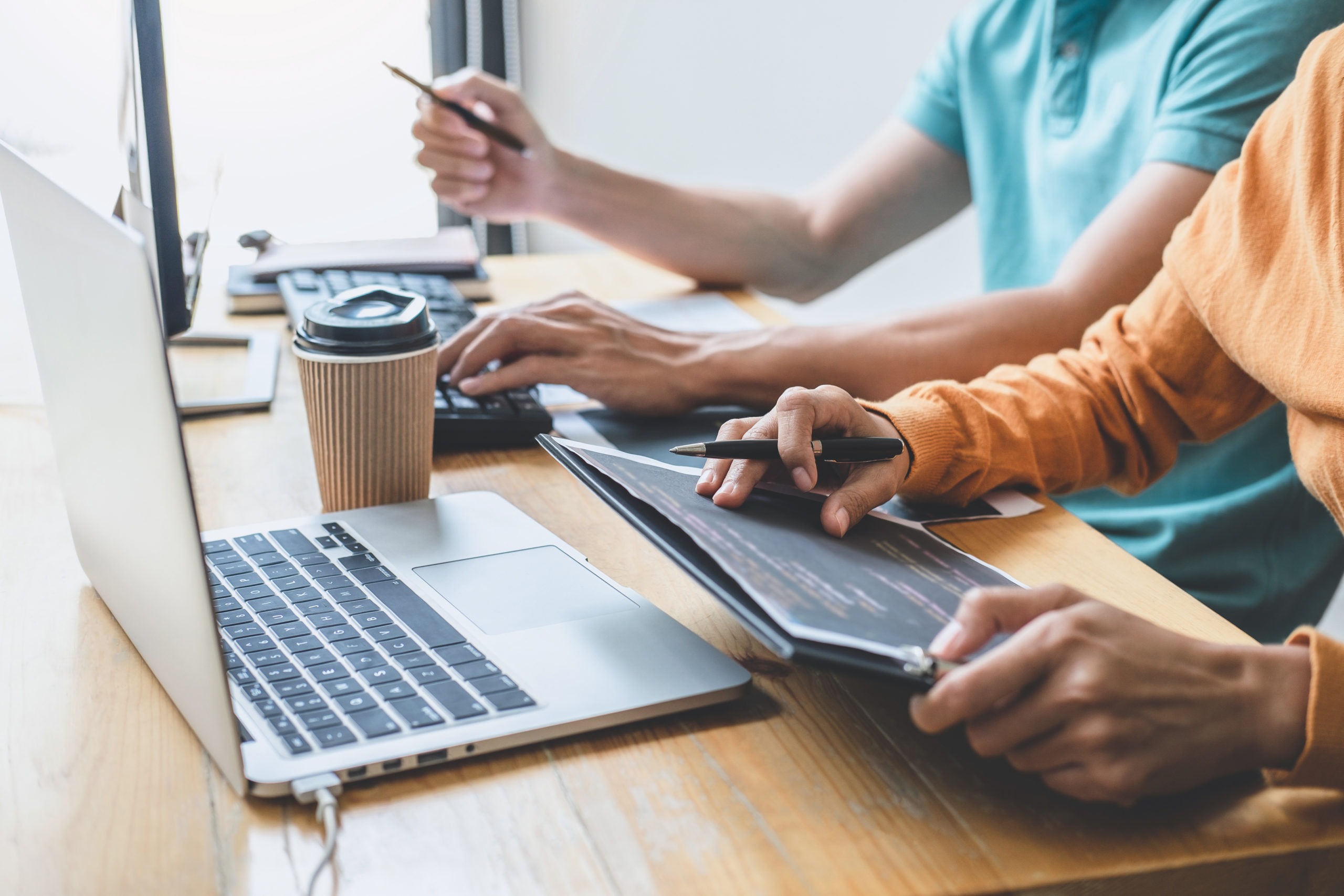 Programmers cooperating at Developing programming and website working in a software develop company office, writing codes and typing data code, Programming with HTML, PHP and javascript.