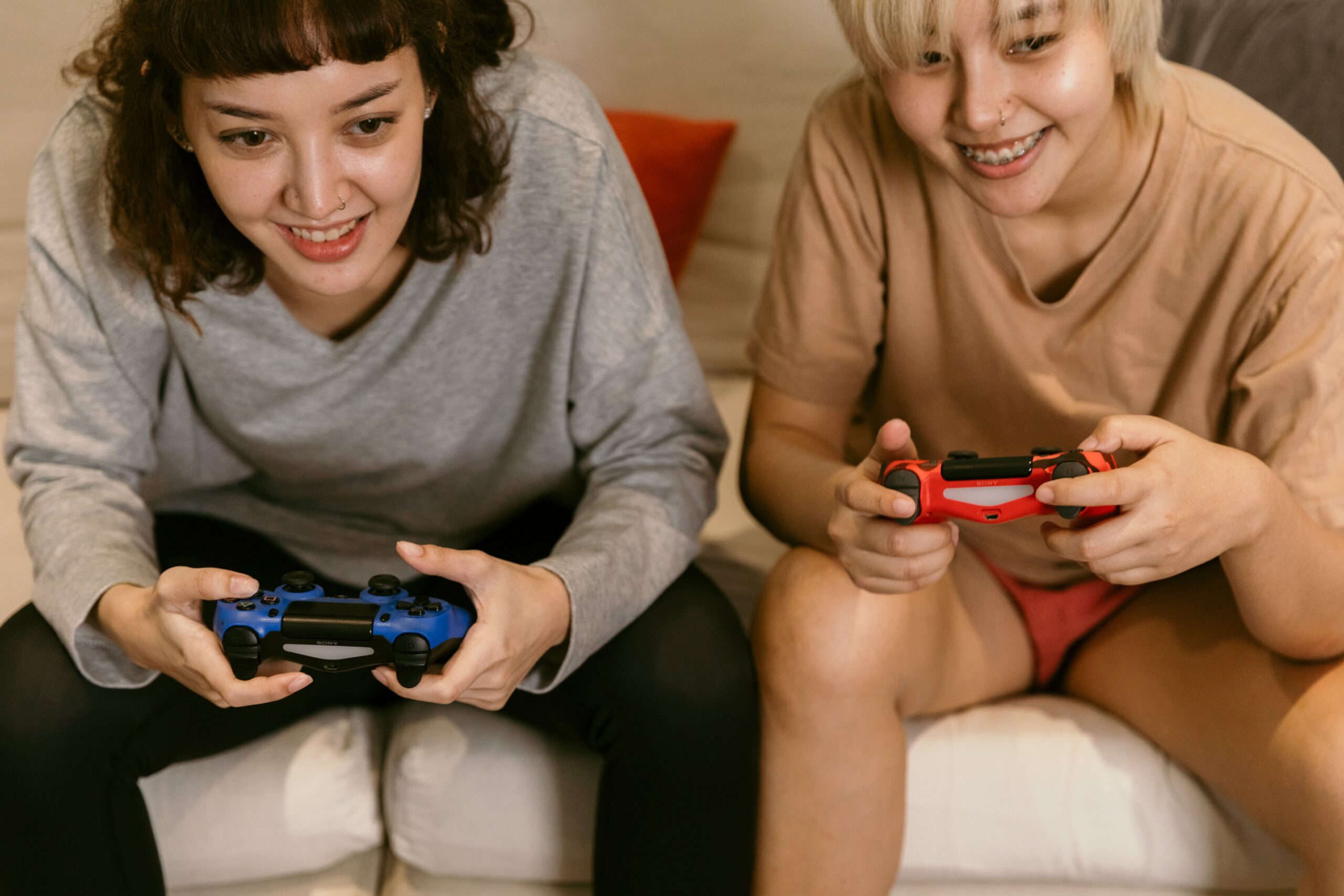 crop asian girlfriends playing video games at home
