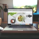 An image of a laptop that has a website about food open on its screen.