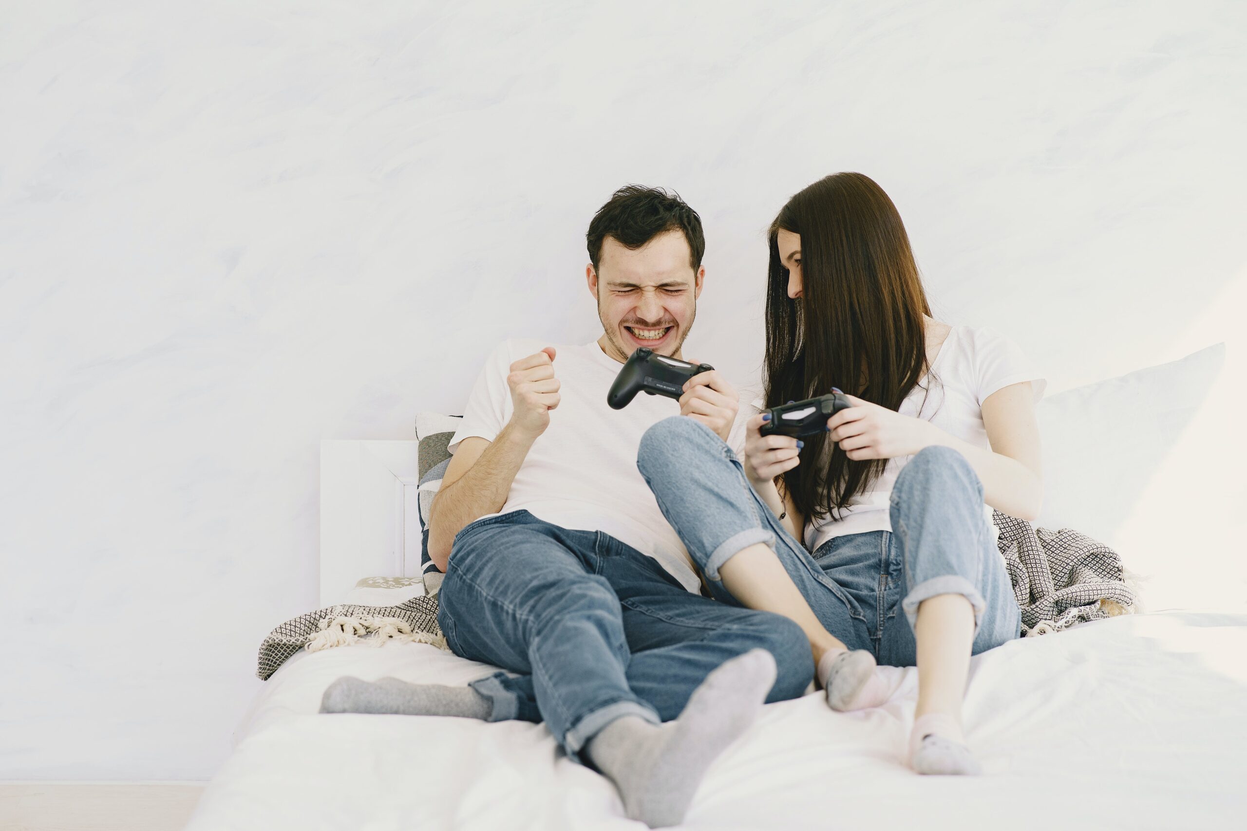 cheerful couple spending time together while playing game console